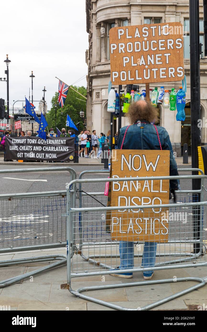 Plastic producers planet polluters now ban all dispo plastics - man holding banner at London, UK in June Stock Photo