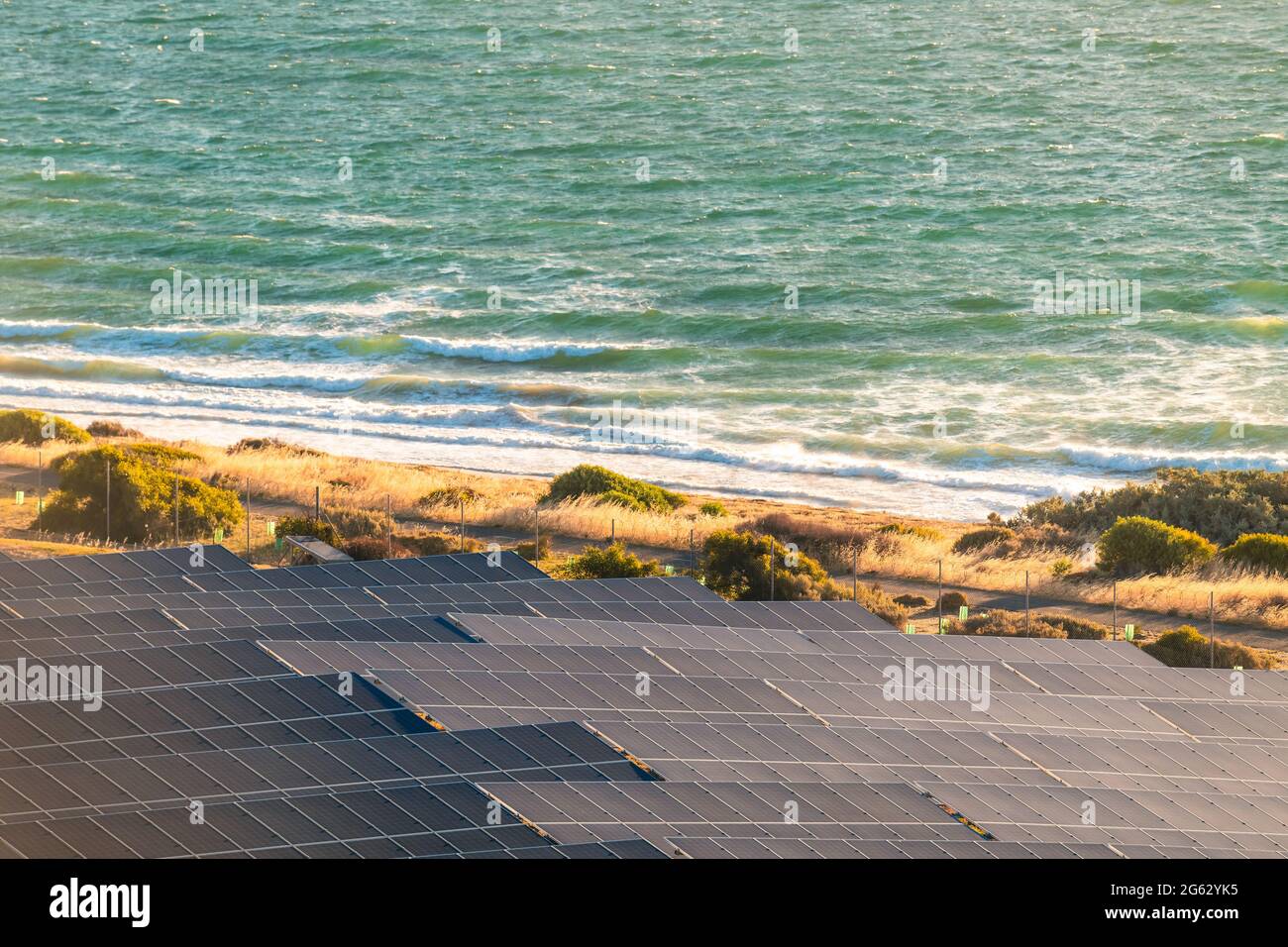 Solar panels installed along the sea shore at sunset in South Australia Stock Photo