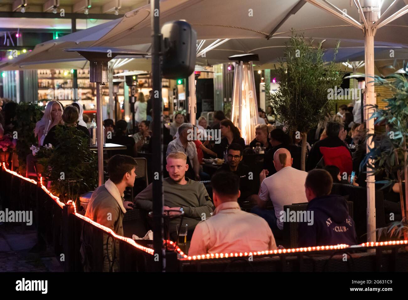 Stockholm, Sweden. 01st July, 2021. People sit at the tables outside a
