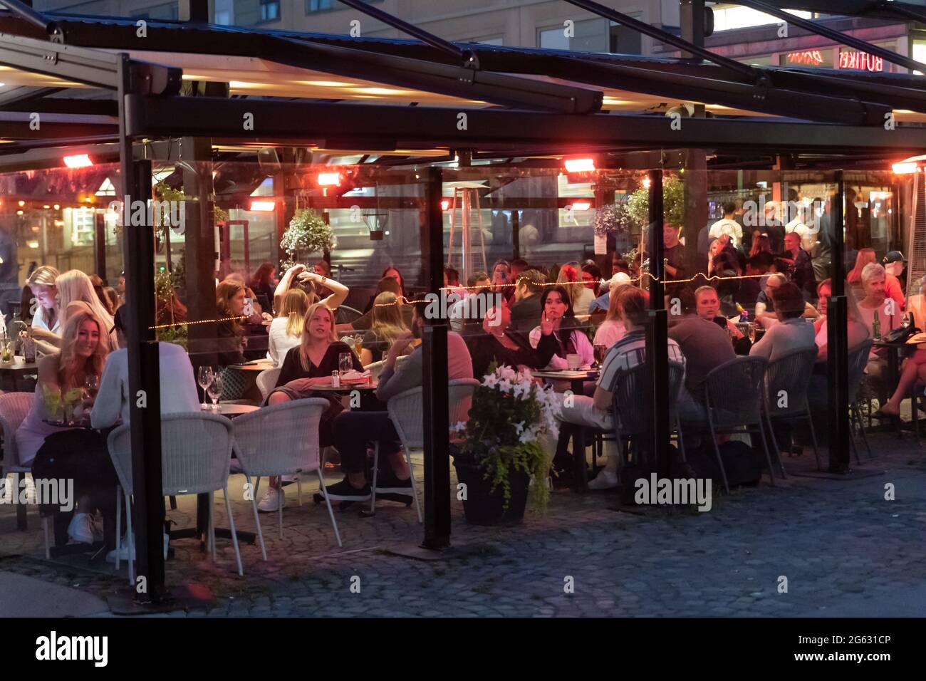Stockholm, Sweden. 01st July, 2021. People sit at the tables outside a