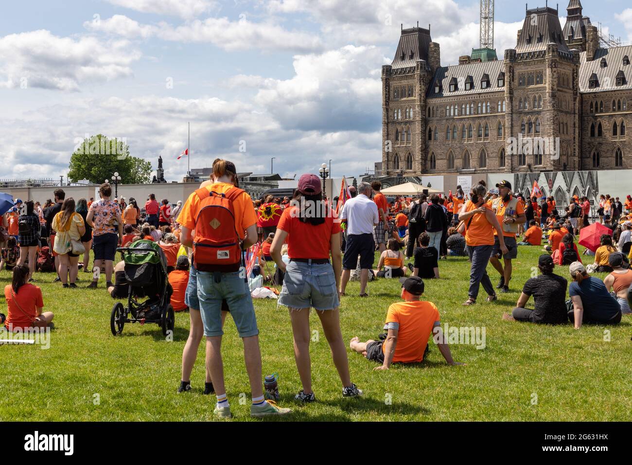 Ottawa, Canada - July 1, 2021: Cancel Canada Day protest rally on Parliament Hill in support of Indigenous people. Every Child Matters. People wearing Stock Photo