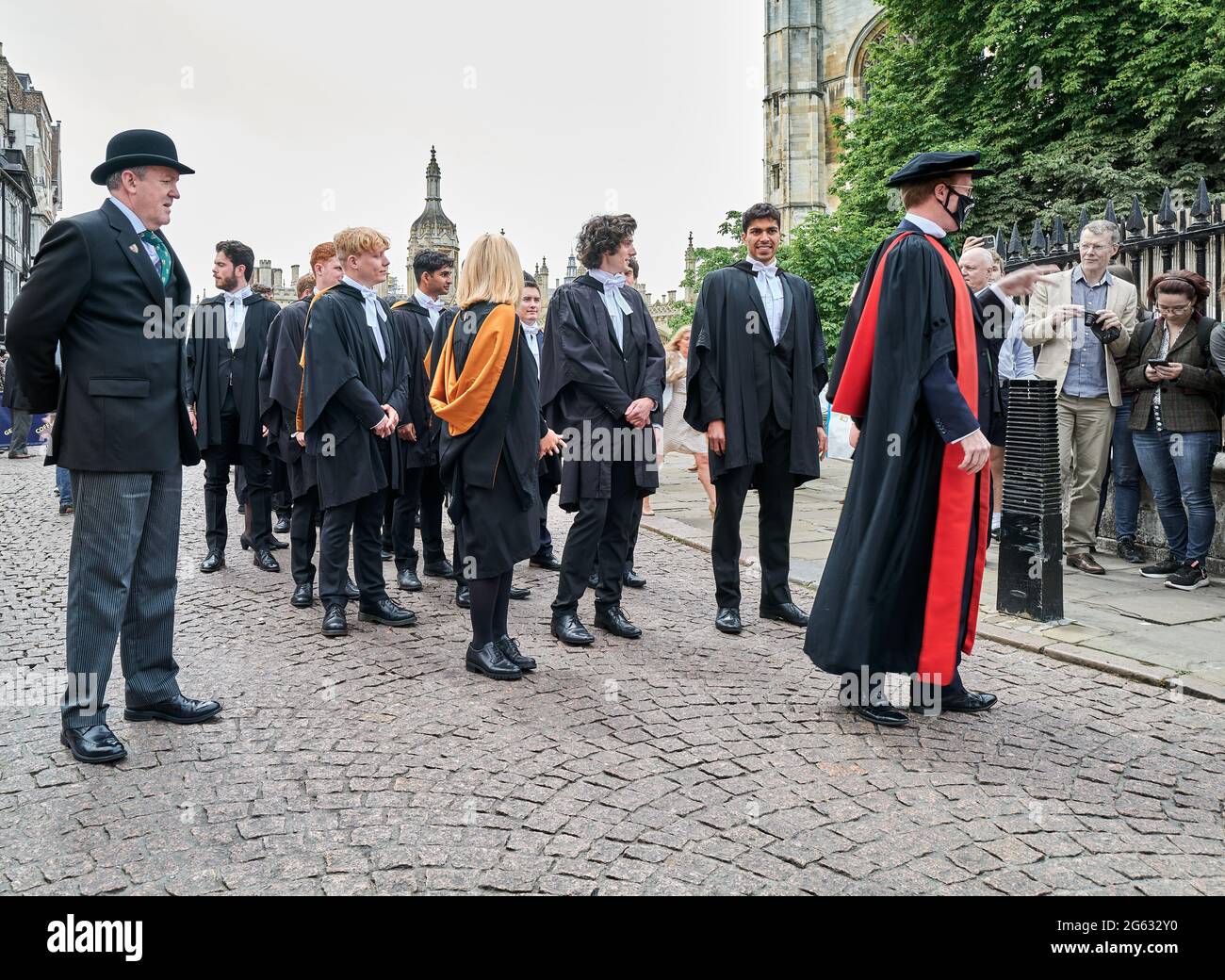 Undergraduate students from Queens' college, university of Cambridge, England, queue to enter Senate house for their graduation ceremony, 1st July 2021. Stock Photo