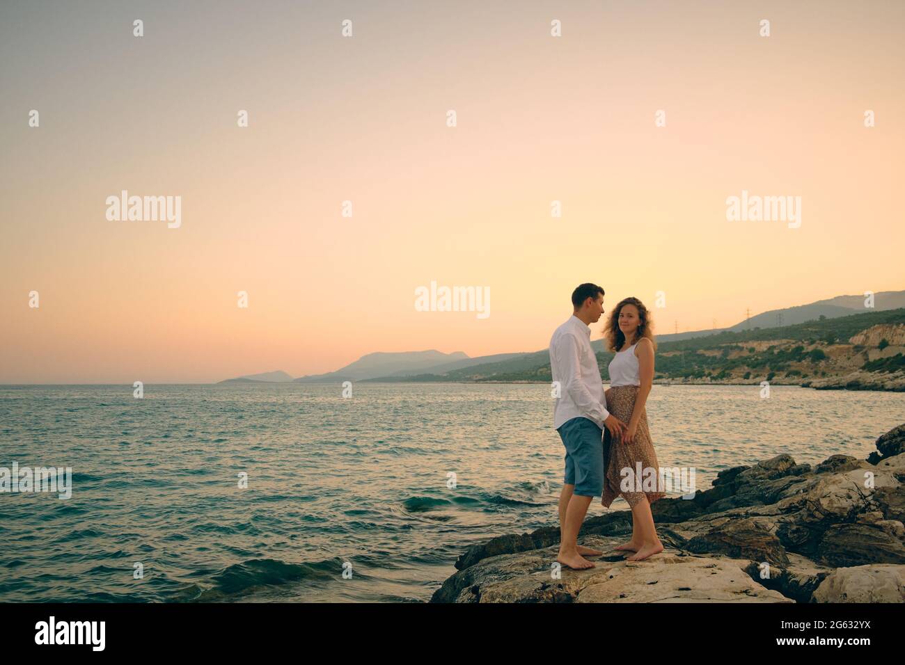Couple on an evening seaside date Stock Photo