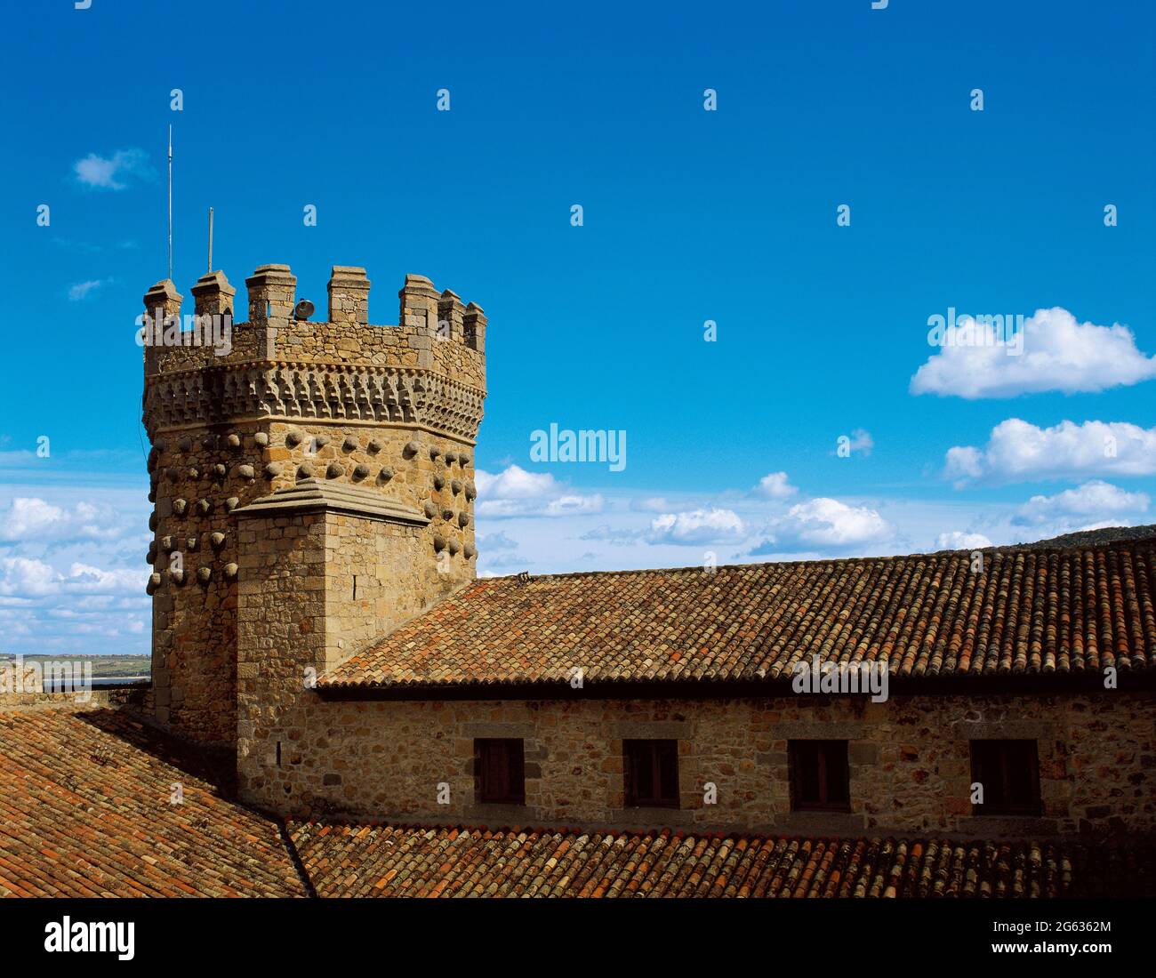 Spain, Community of Madrid, Manzanares El Real Castle. Built in 1475 by order of Diego Hurtado de Mendoza, was the residence of the Mendoza family until late 16th century. View of the Homage Tower, decorated with balls and framed in limestone rhombuses in the Elizabethan style. Stock Photo