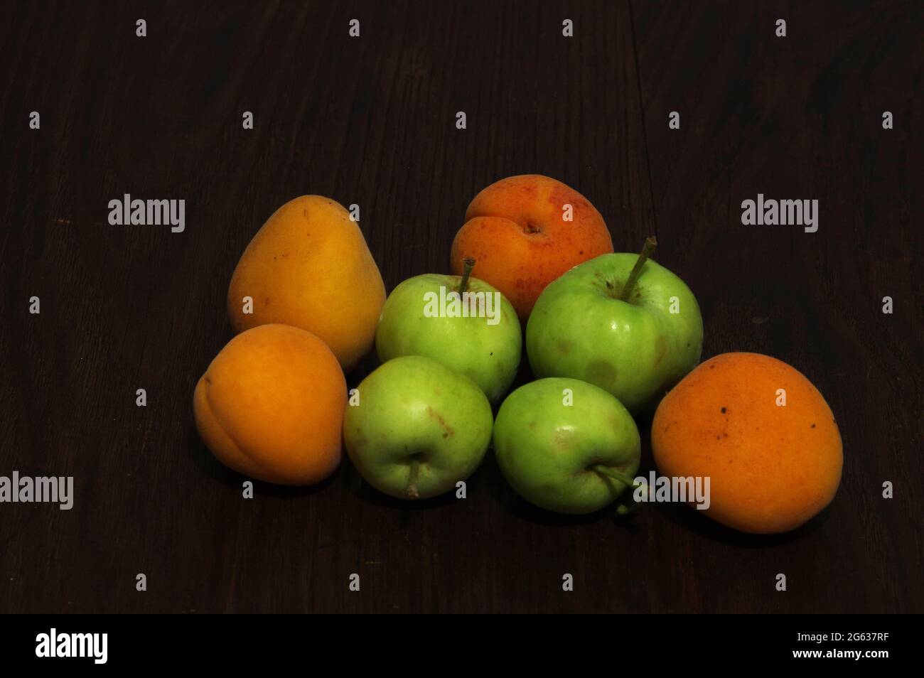 Apricots and apples on wooden table Stock Photo