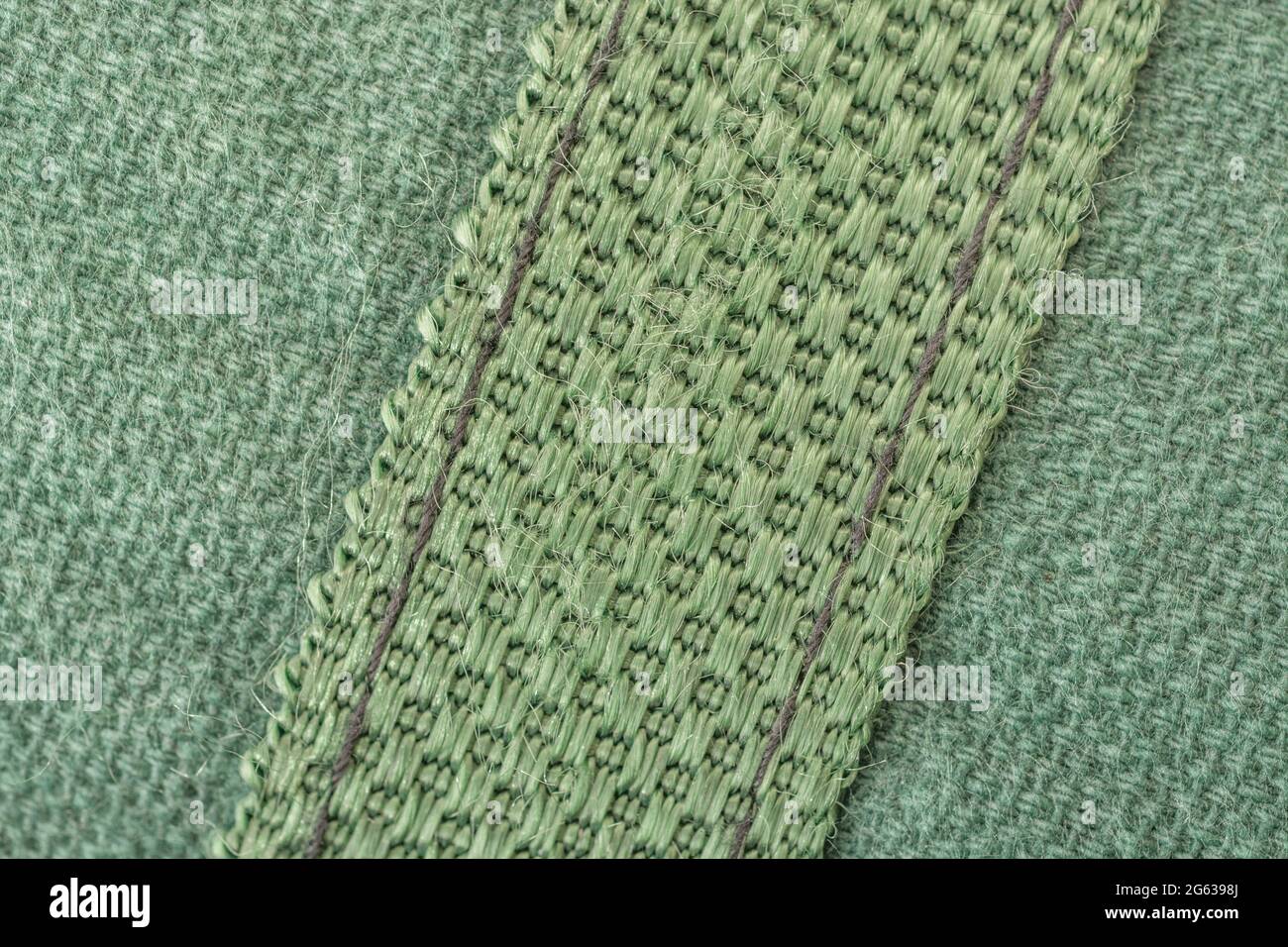 Abstract close-up macro shot of heavy duty stitching / stitches of canvas item. For stitch in time idiom, well secured, outdoor skills, bushcraft. Stock Photo