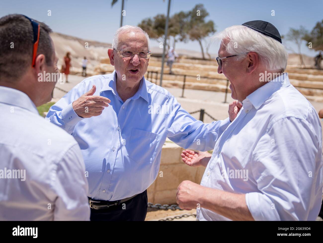 Negev, Israel. 02nd July, 2021. Federal President Frank-Walter Steinmeier (r) and Israeli President Reuven Rivlin (m) stand in the Negev Desert at the gravesite of the founder of the State of Israel, David Ben-Gurion and Paula Ben-Gurion. The German President's state visit to Israel ends after three days. Credit: Kay Nietfeld/dpa/Alamy Live News Stock Photo