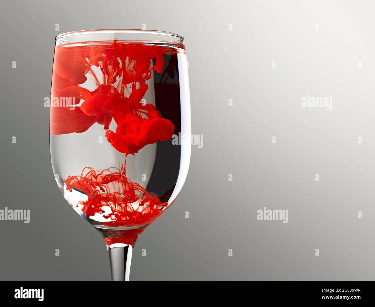 Red ink drop into water glass and abstract emulsion Stock Photo - Alamy