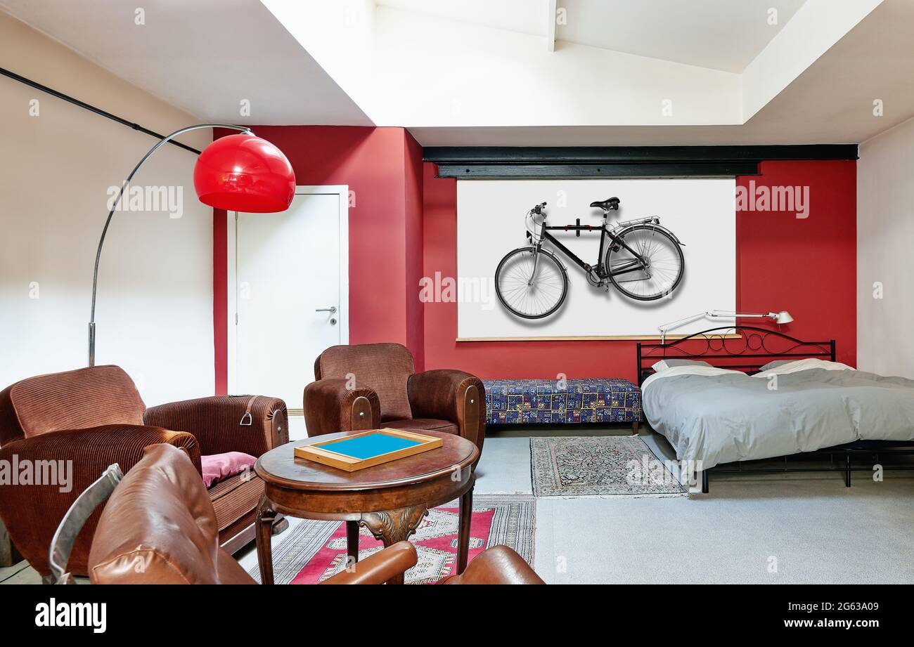 Vintage Hipster loft bedroom with bike on wall on wall. Stock Photo