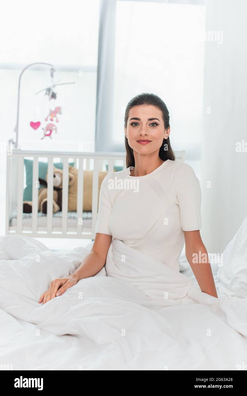 Woman looking at camera on bed hi-res stock photography and images - Alamy
