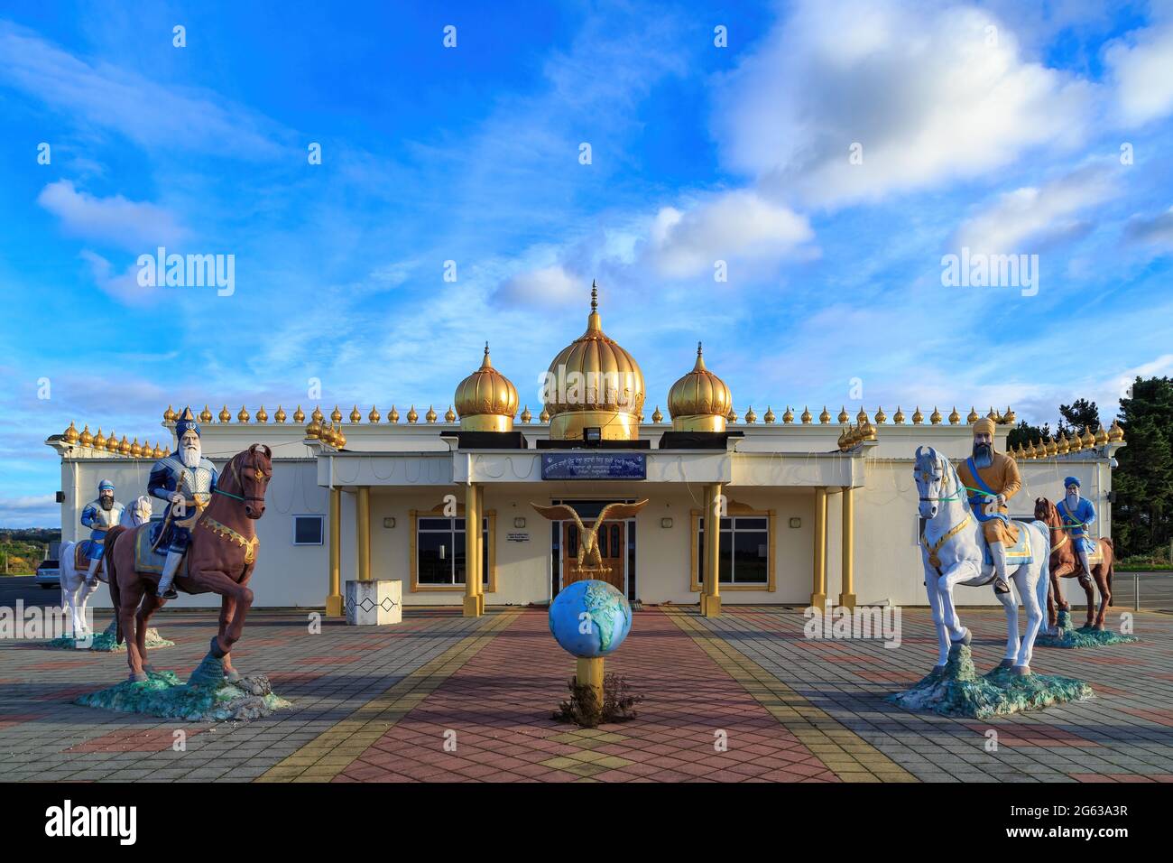 A Sihk temple in Tauranga, New Zealand, the Gurudwara Kalgidhar Sahib. Outside are statues of Sikh warriors Stock Photo