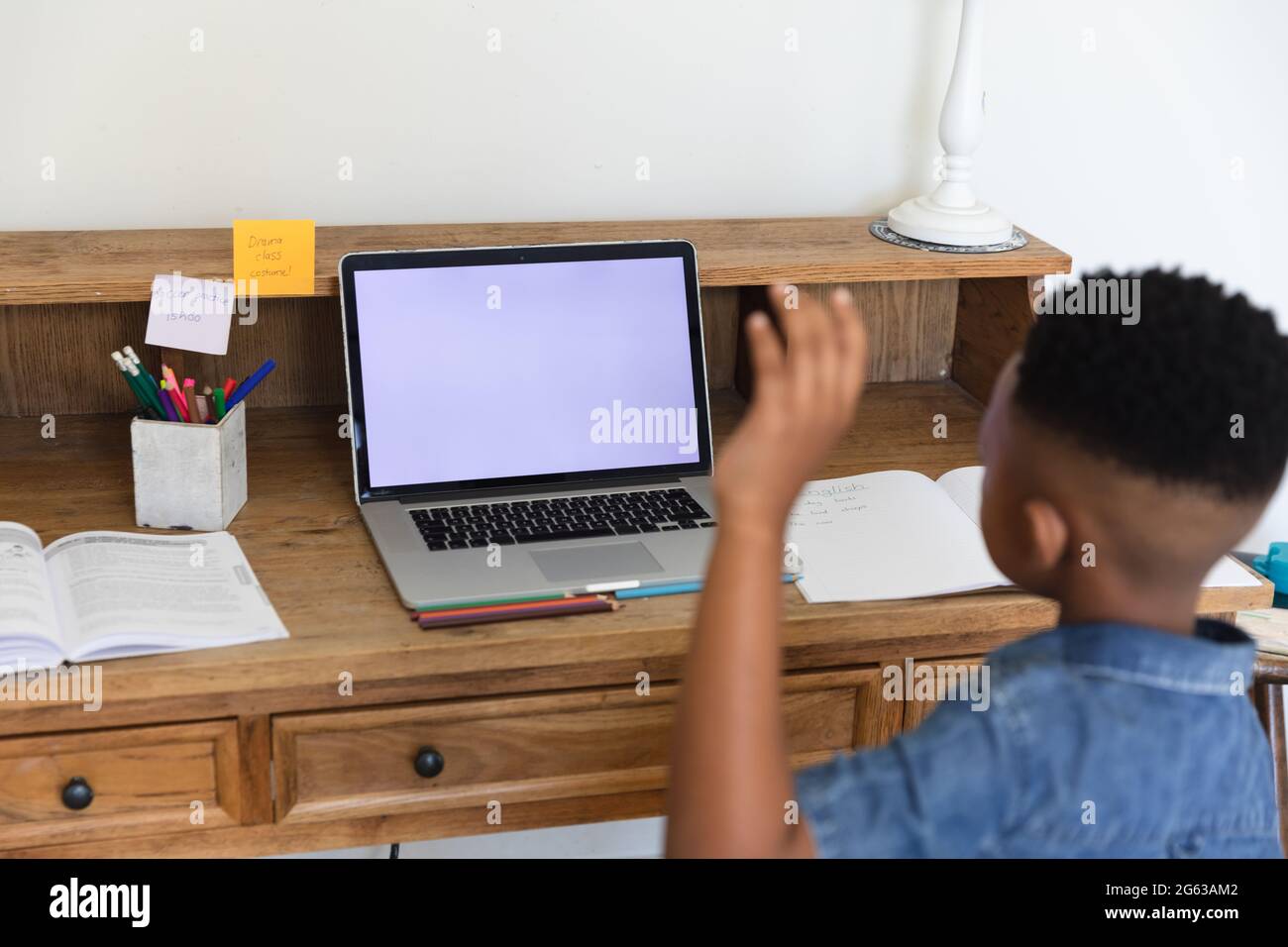 African american boy having video call lesson using laptop during class ...
