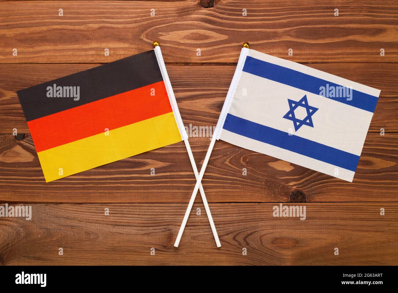 Flag of Germany and flag of Israel crossed with each other. The image illustrates the relationship between countries. Photography for news Stock Photo
