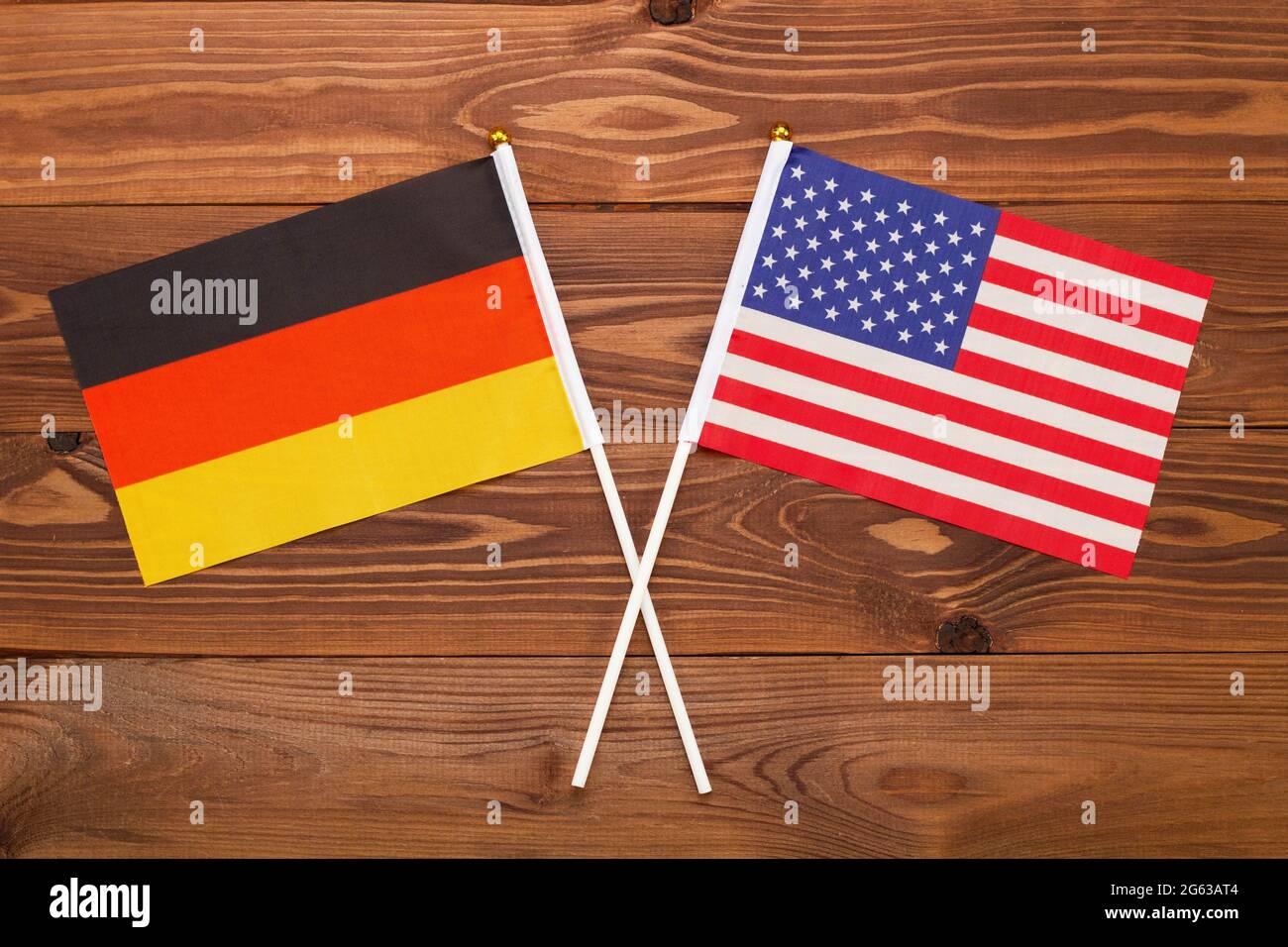 Flag of Germany and flag of USA crossed with each other. The image illustrates the relationship between countries. Photography for news Stock Photo
