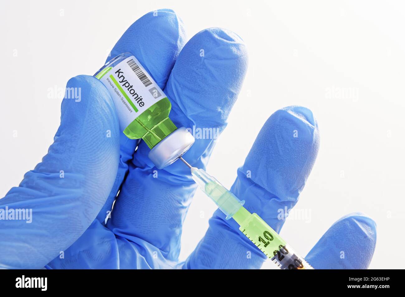Close-up of hand in gloves holding a vial with kryptonite and extracting fluid to syringe for injection. Healthcare, medicine, pharmacy, vaccination Stock Photo