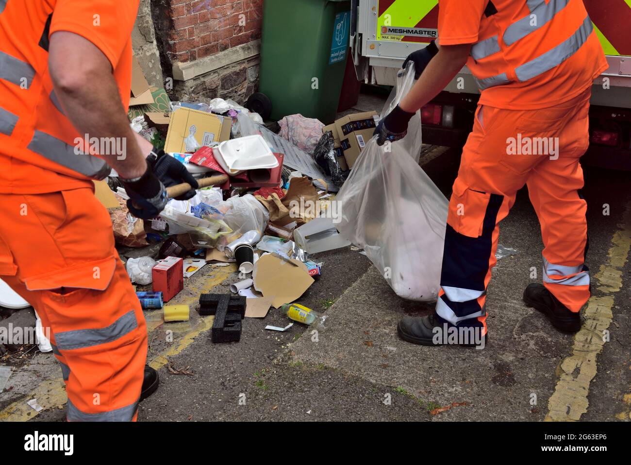 Council crew cleaning up street of fly tipped rubbish left by students departing university at end of term, UK Stock Photo