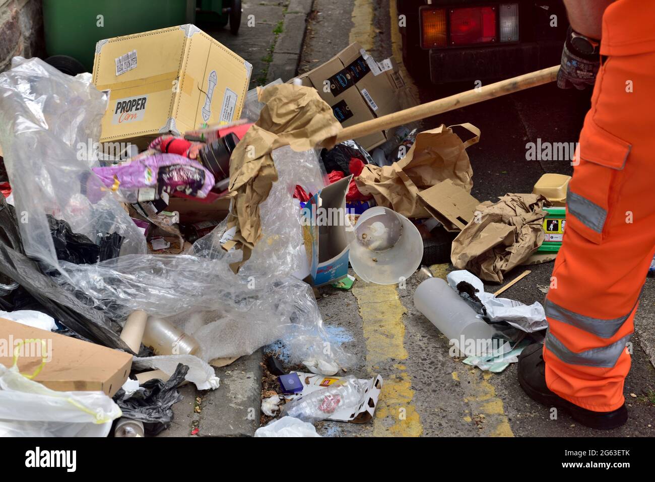 Council crew cleaning up street of fly tipped rubbish left by students departing university at end of term, UK Stock Photo