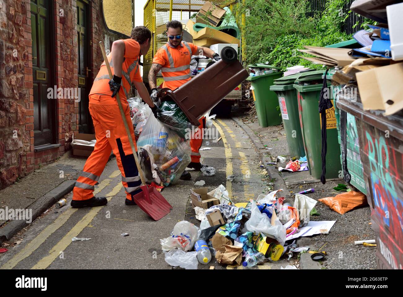 Council crew cleaning up street of fly tipped rubbish left by students departing university at end of term, UK Stock Photo