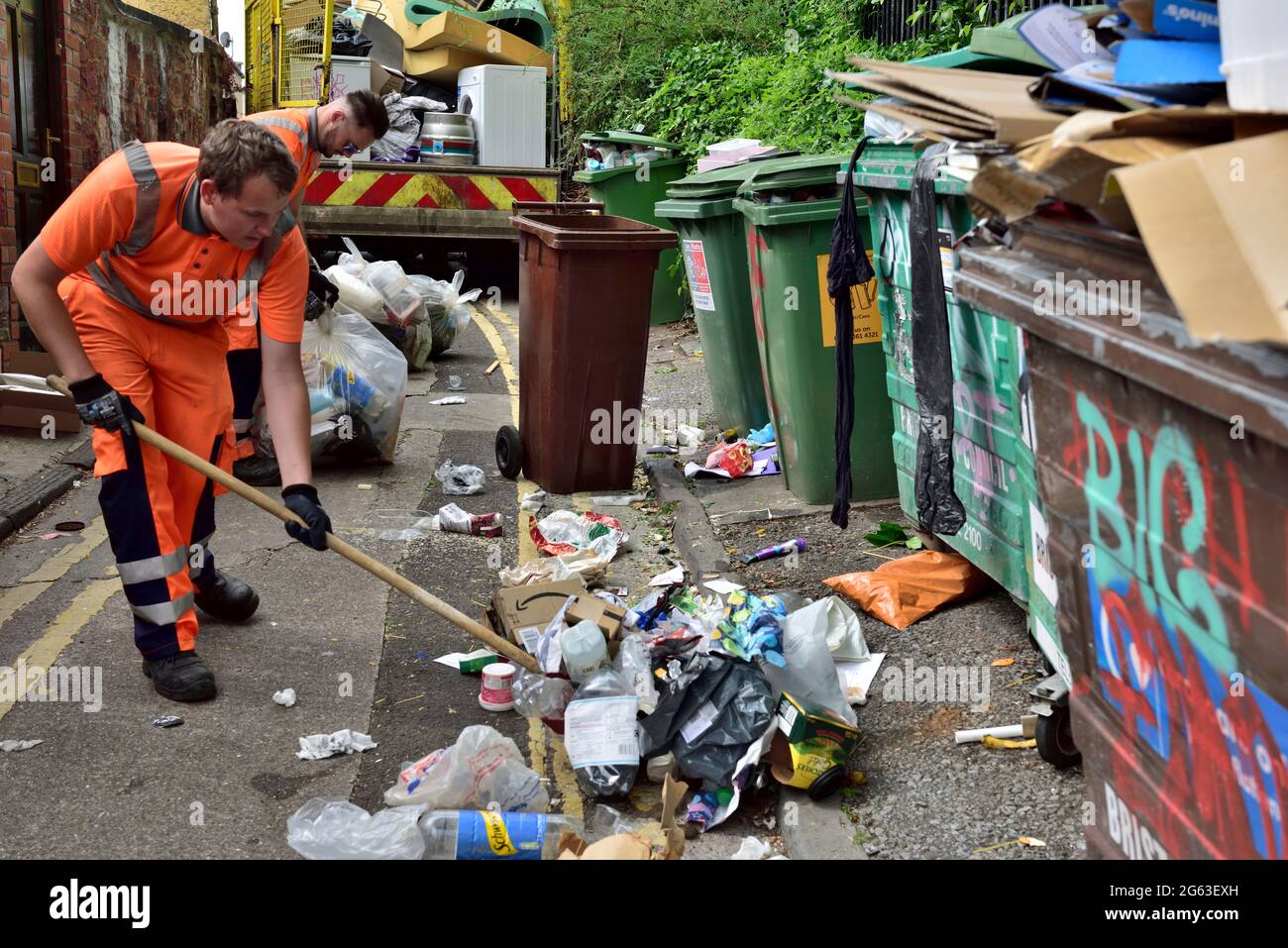 Council crew cleaning up street of fly tipped rubbish left by students departing university at end of term, UK Stock Photo