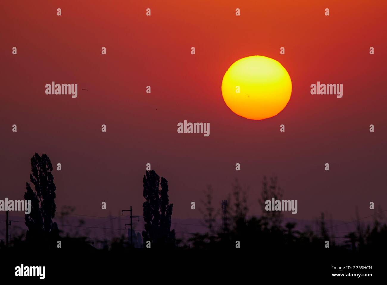 Sunset with a visible solar explosion on the surface of the sun Stock ...
