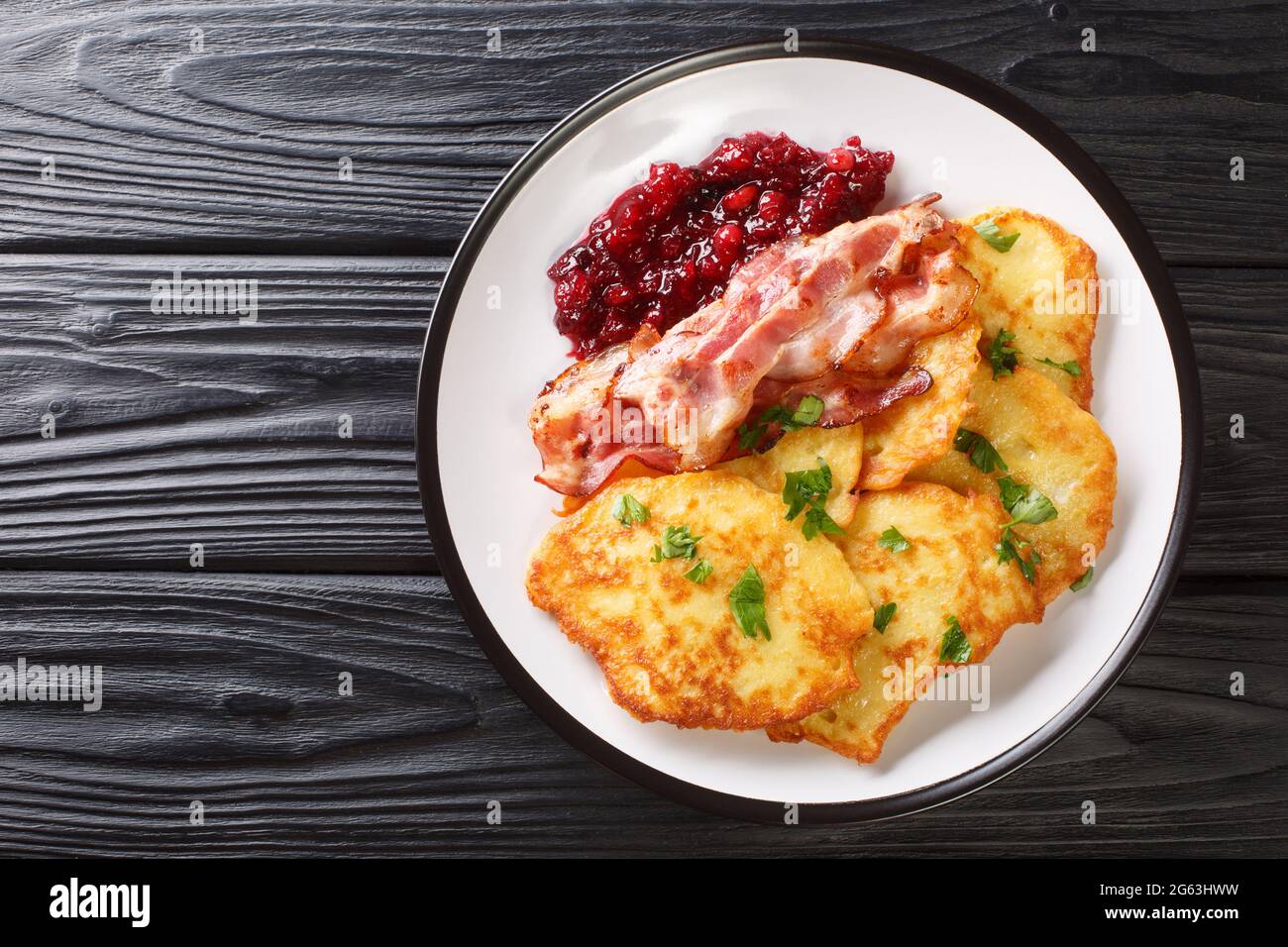 Swedish potato pancakes with fried pork raggmunk med flask close-up in a  plate on the table. horizontal top view from above Stock Photo - Alamy