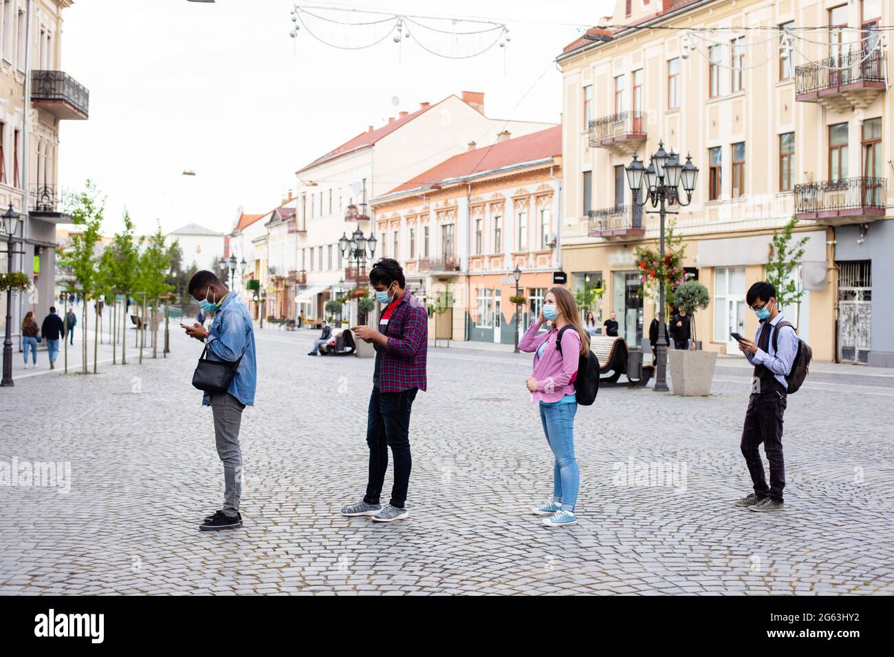 People in masks stand queue keeping social distance Stock Photo - Alamy
