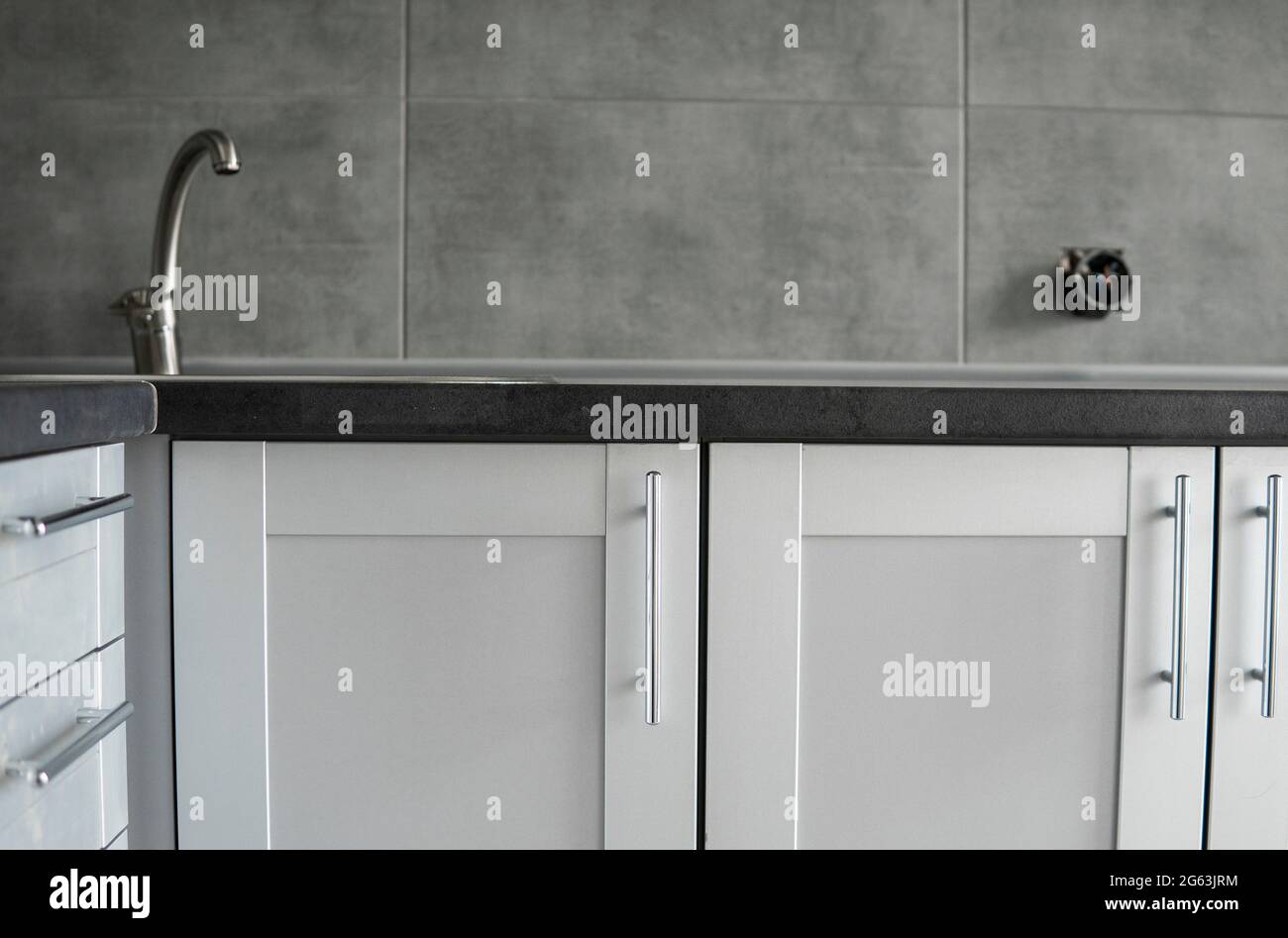 Modern minimalist style kitchen close up in monochrome tones. Custom