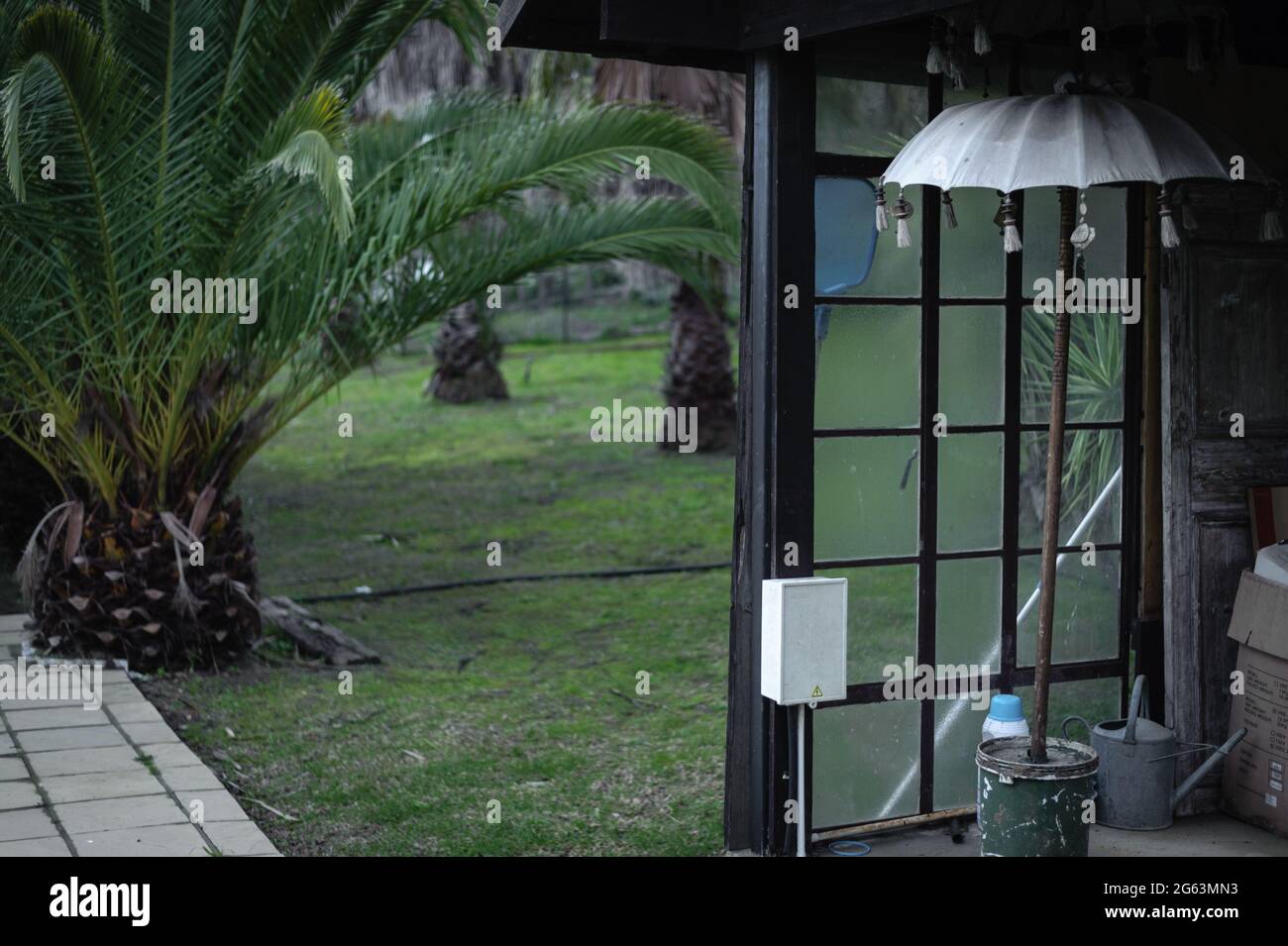 A sun umbrella stands in a pool house during the winter months in