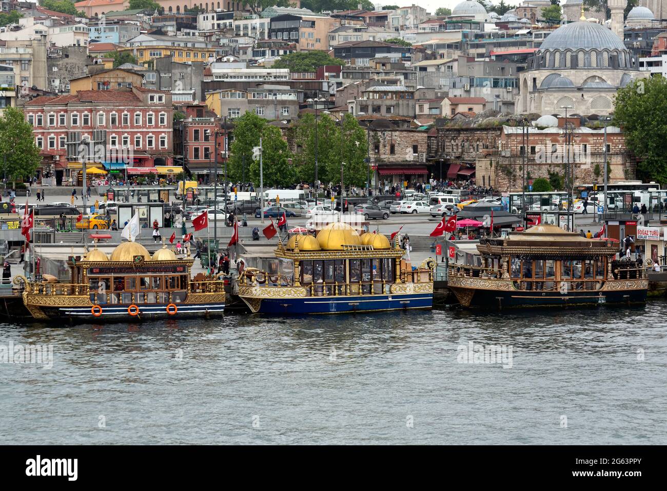 Fish and chips, seafood takeaway street food. Floating restaurant boats with oriental and Ottoman theme in Eminonu, Istanbul, Turkey. Stock Photo