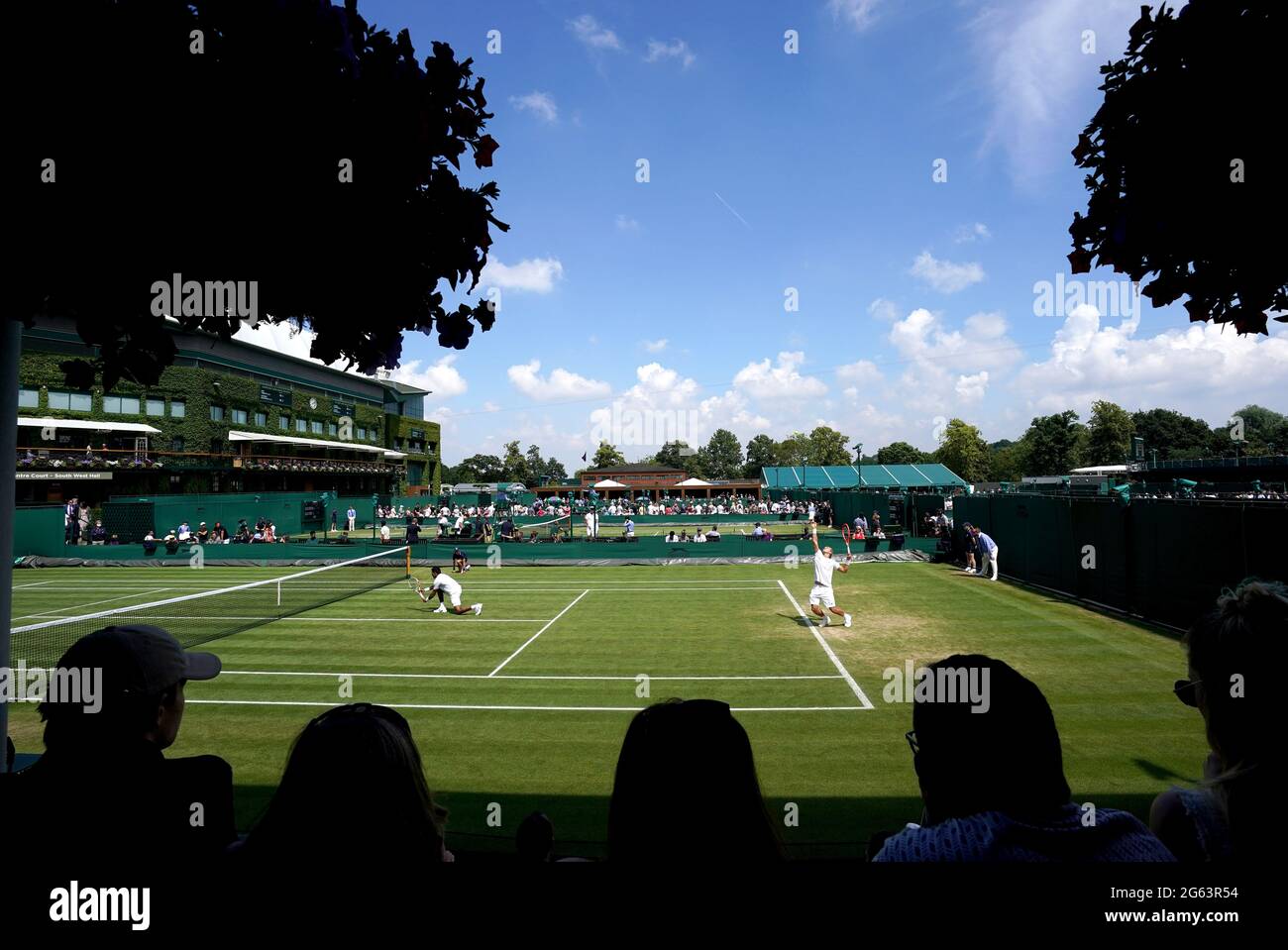 Fans watch the action on court four between Alexander Bublik and Aleksandr Nedovyesov take on Rafael Matos and Thiago Monteiro on day five of Wimbledon at The All England Lawn Tennis and Croquet Club, Wimbledon. Picture date: Friday July 2, 2021. Stock Photo