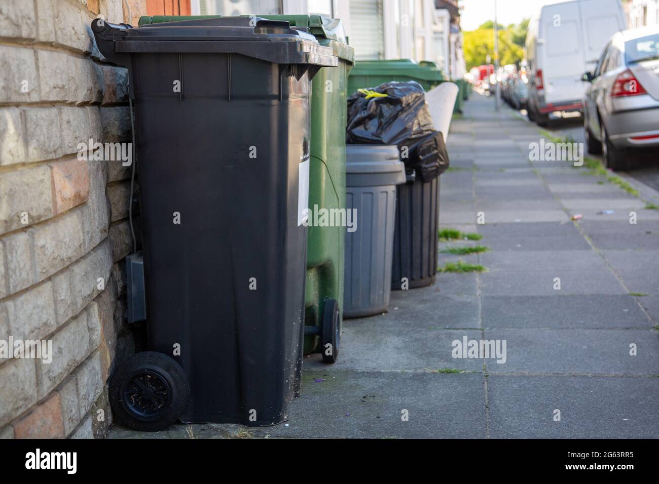Rubbish bins and recycling bins outside homes on a n english street Stock Photo