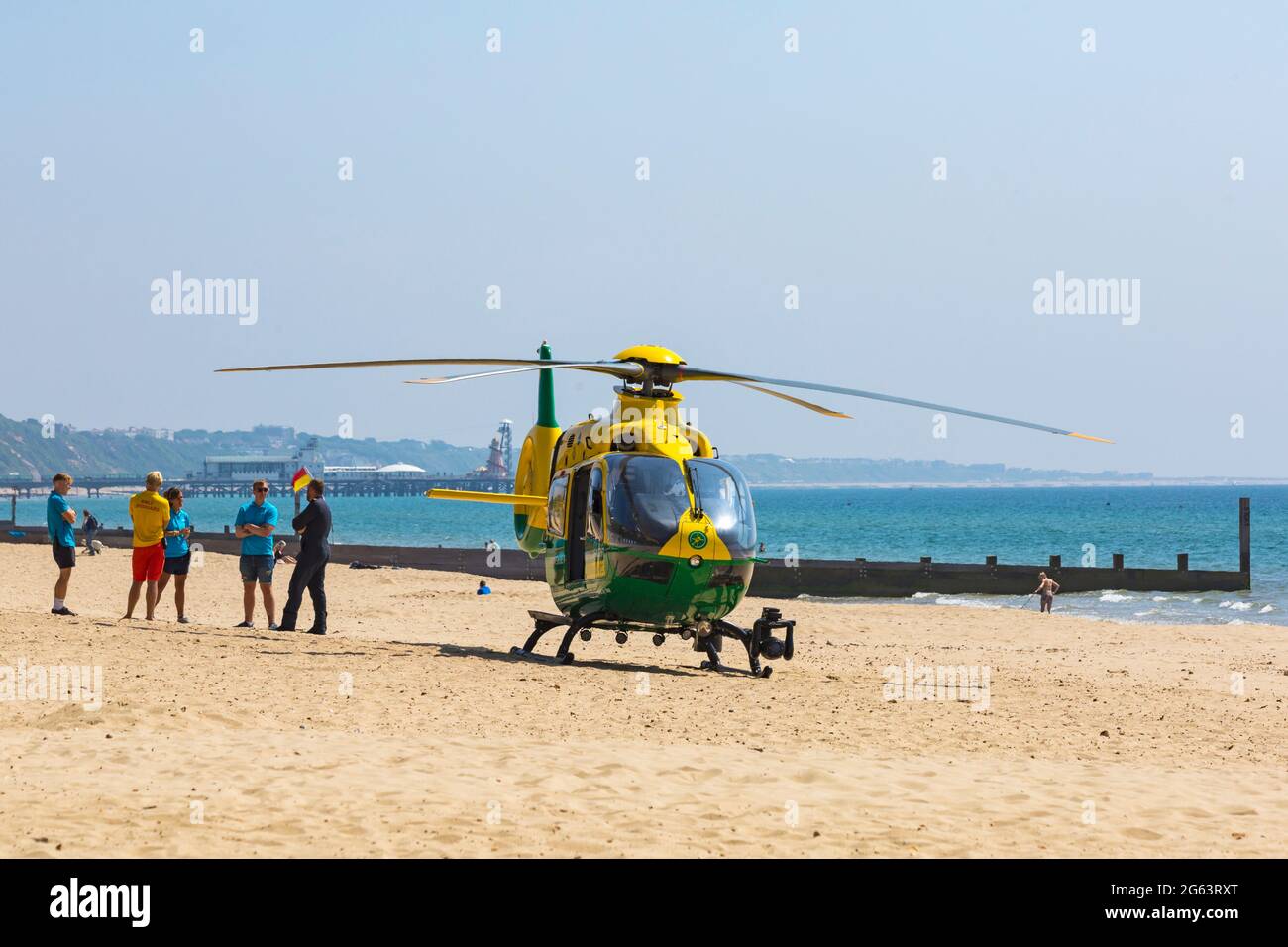 Bournemouth, Dorset UK. 2nd July 2021. Hampshire & Isle Of Wight Air Ambulance helicopter lands on Alum Chine beach, Bournemouth to attend a medical incident on the cliff top. Credit: Carolyn Jenkins/Alamy Live News Stock Photo