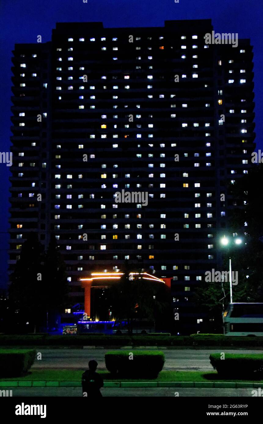 A well lit hotel at night in North Korea, Pyongyang, but no one visible in the rooms Stock Photo