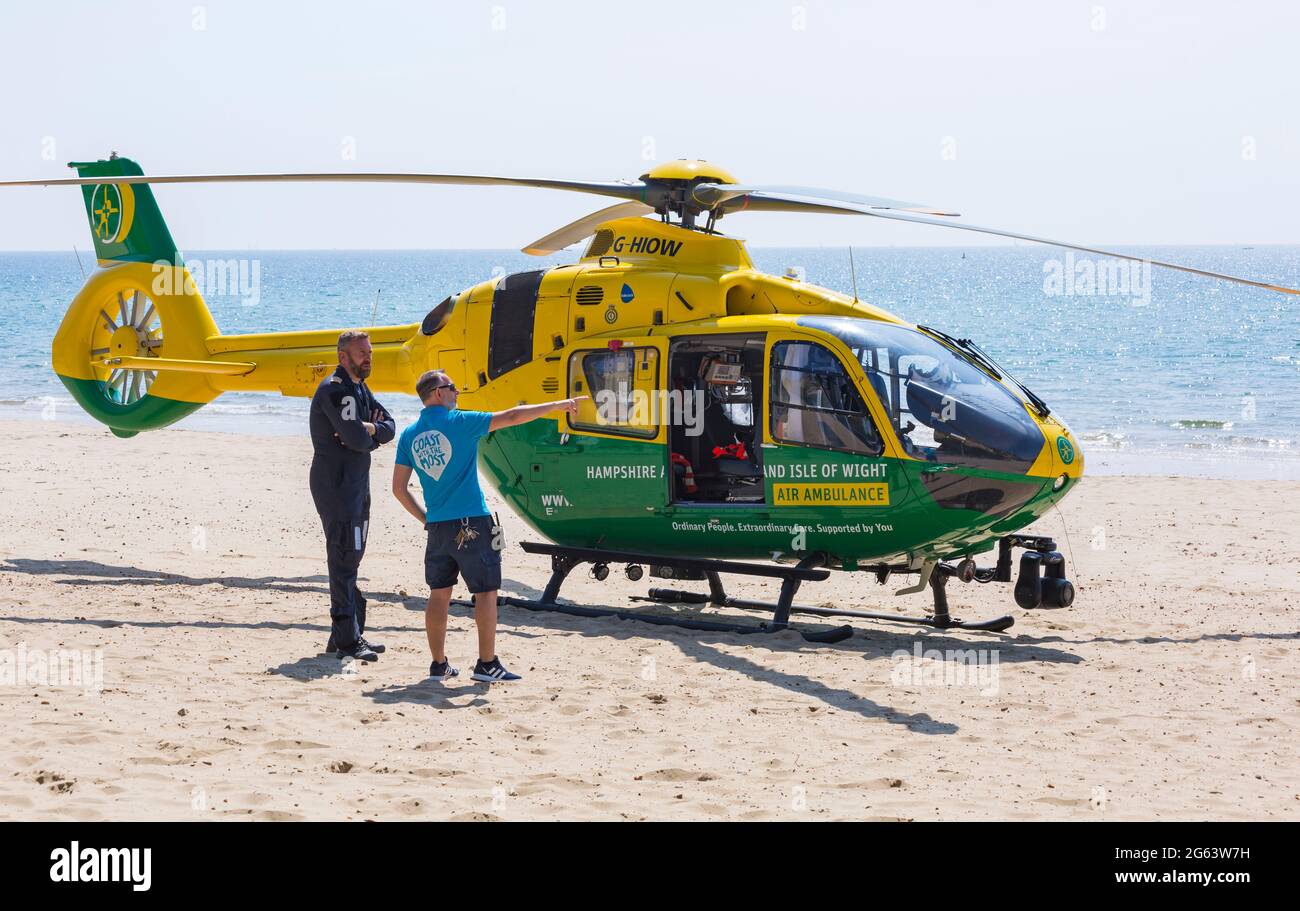 Bournemouth, Dorset UK. 2nd July 2021. Hampshire & Isle Of Wight Air Ambulance helicopter lands on Alum Chine beach, Bournemouth to attend a medical incident on the cliff top. Credit: Carolyn Jenkins/Alamy Live News Stock Photo