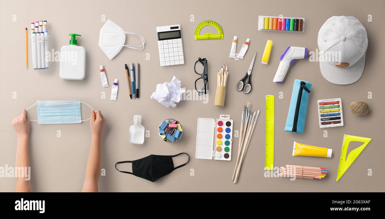 Flat lay top view of face mask and school supplies, back to school and ...