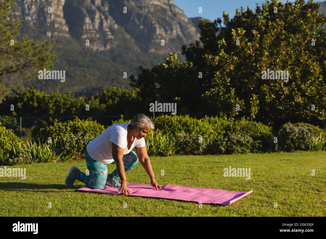 Woman kneeling on the grass hi-res stock photography and images - Alamy