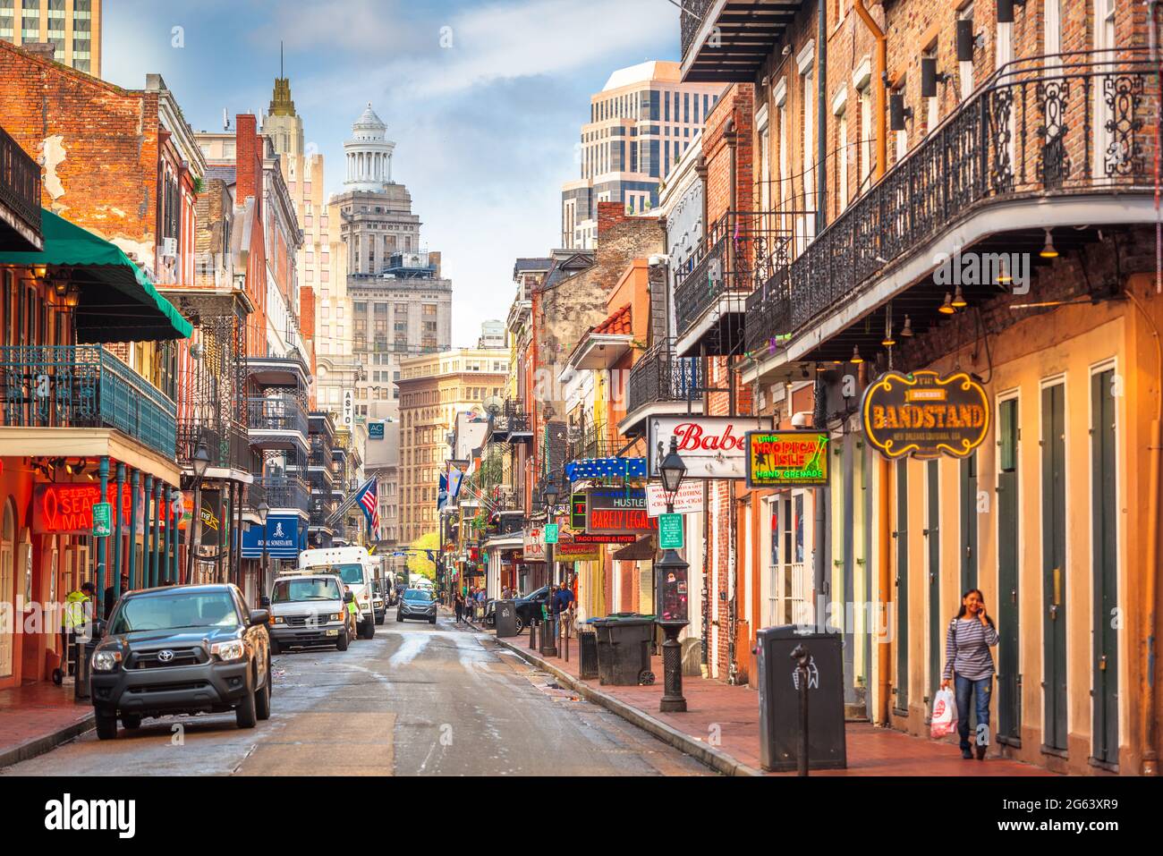 NEW ORLEANS, LOUISIANA - MAY 10, 2016: Traffic and pedestrians on Bourbon Street in the day. The historic street is the heart of the French Quarter. Stock Photo