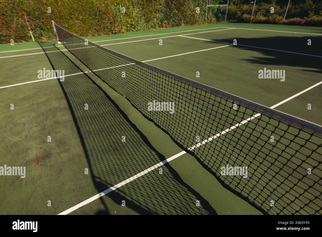 General view of tennis court and tennis net on sunny day Stock Photo
