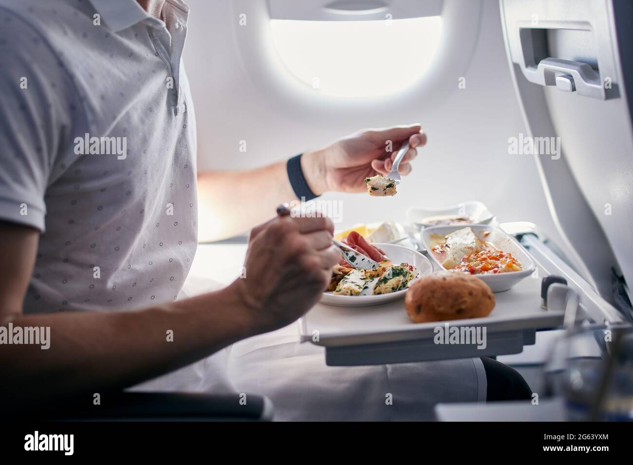 Passenger eating airline meal. Menu in business class on medium haul flight. Stock Photo