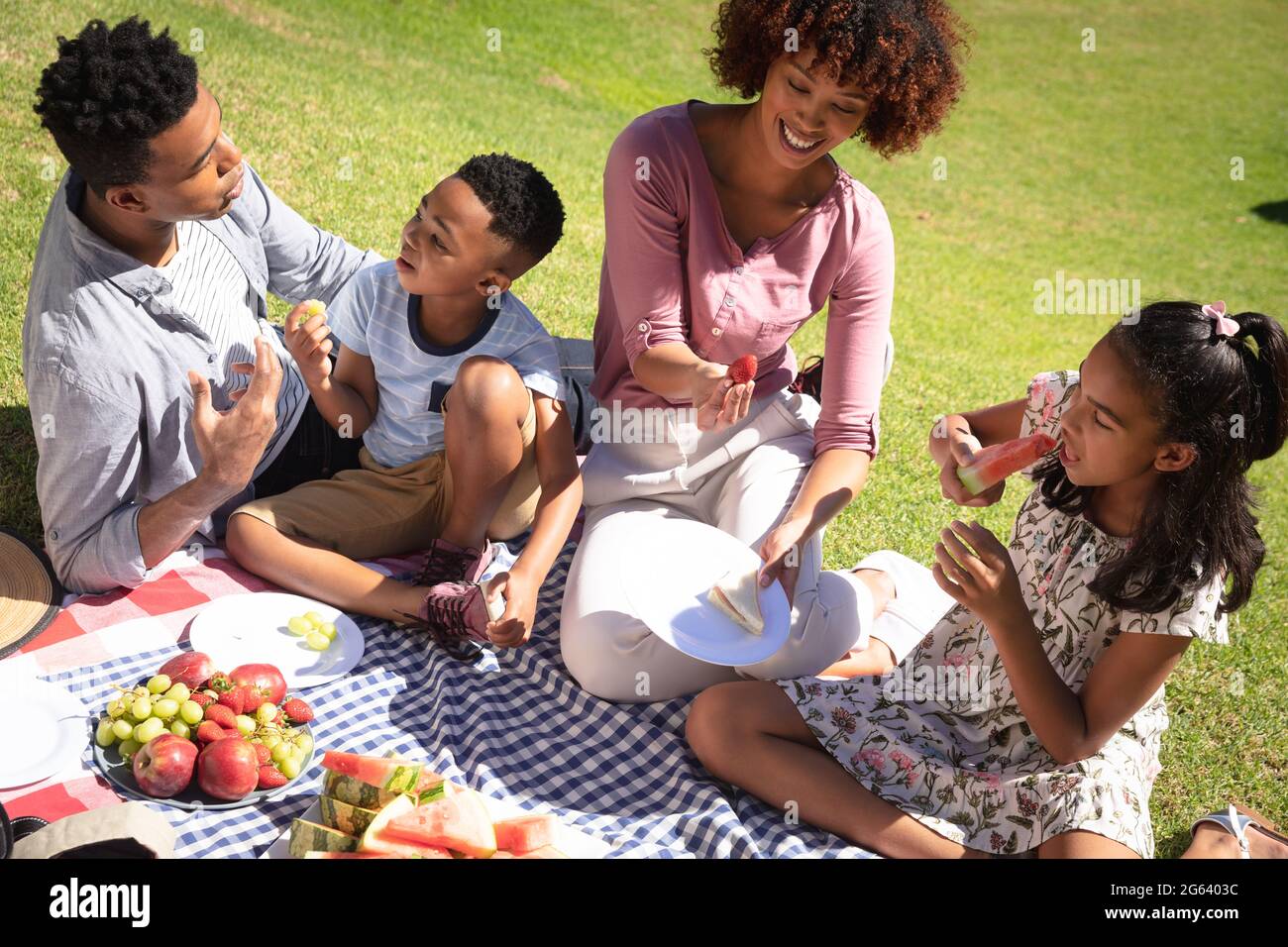 Happy african american couple with son and daughter outdoors, having