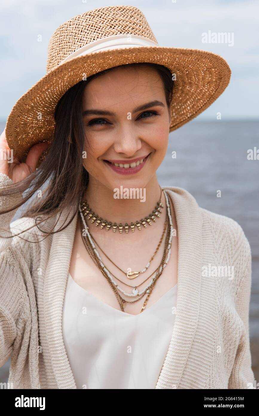 Woman summer hat adjust hi-res stock photography and images - Alamy