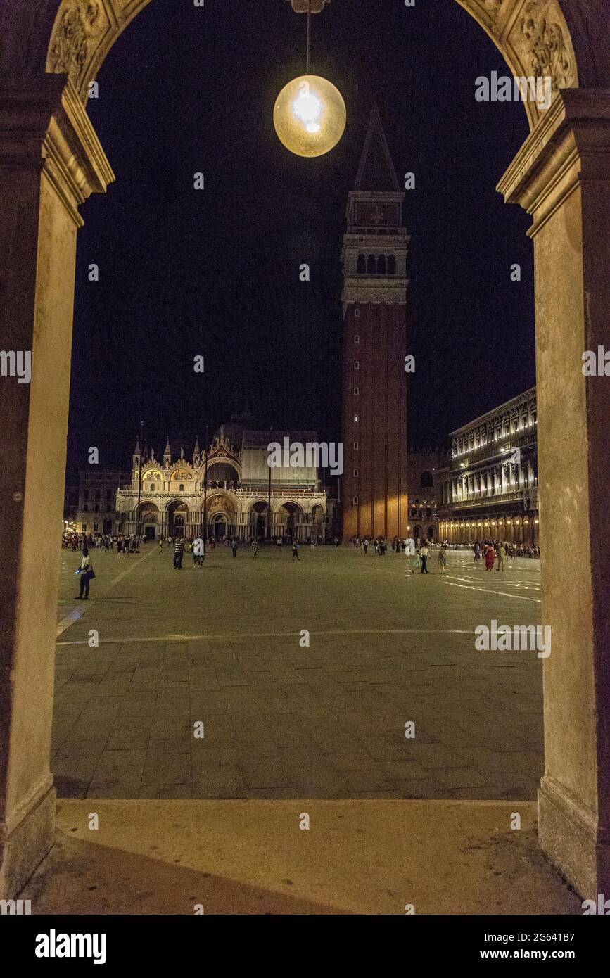 Night scene after dark under the arches facing Piazza San Marco (St. Mark's Square) and towards St.Mark’s Campanile in (Bell Tower) in Venice of north Stock Photo