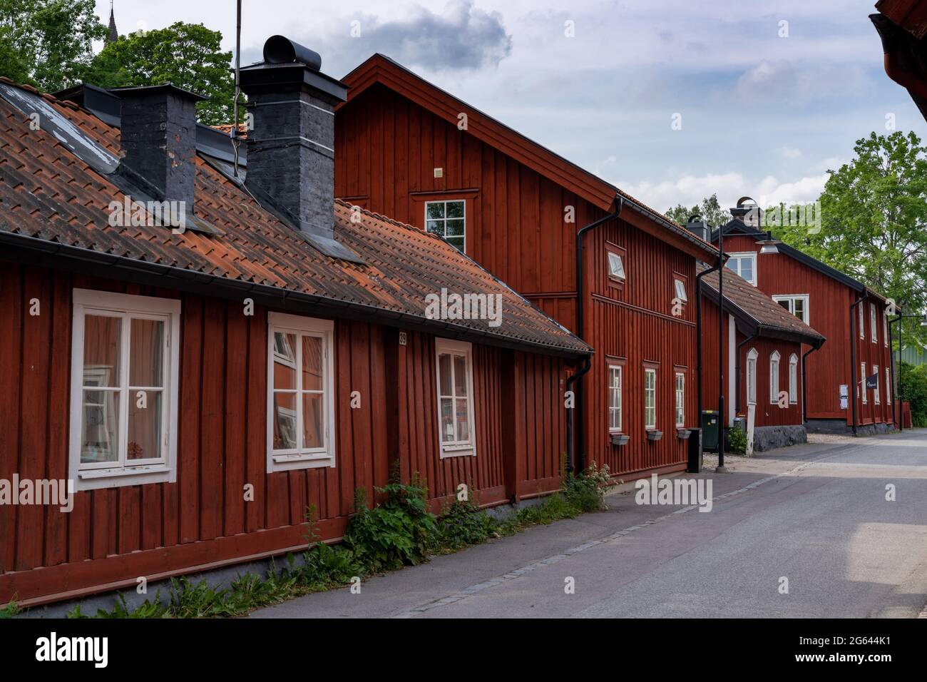 Trosa, Sweden - 22 June, 2021: typical red Swedish wooden houses line the streets of the historic city center of downtown Trosa Stock Photo