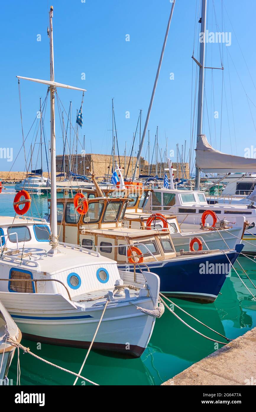 Colorful old fishing boats and yachts in the Venetian Harbor of Heraklion, Crete Island, Greece Stock Photo