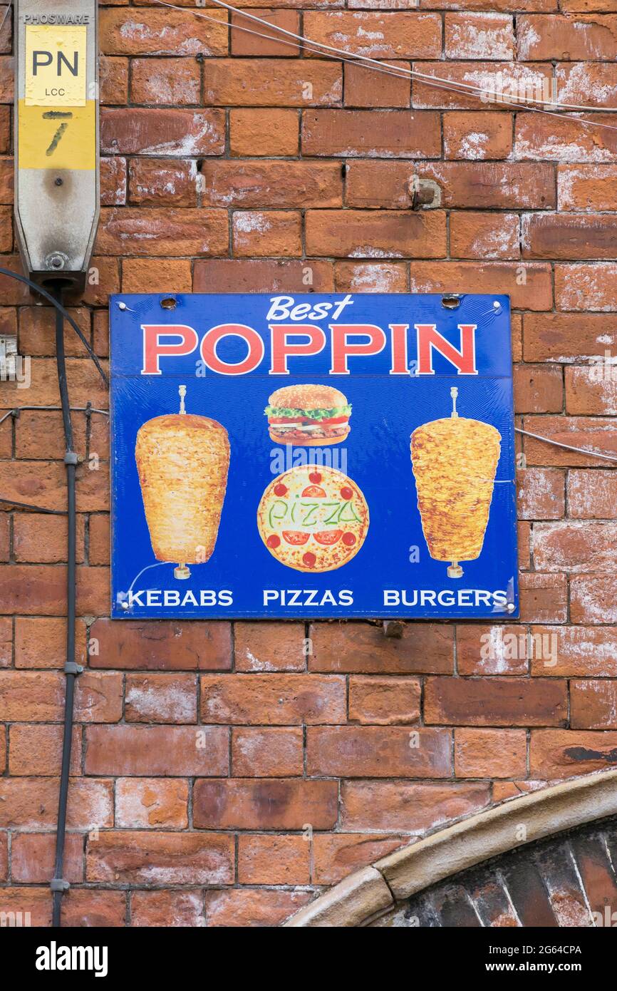 Food outlet sign on brick wall. Stock Photo