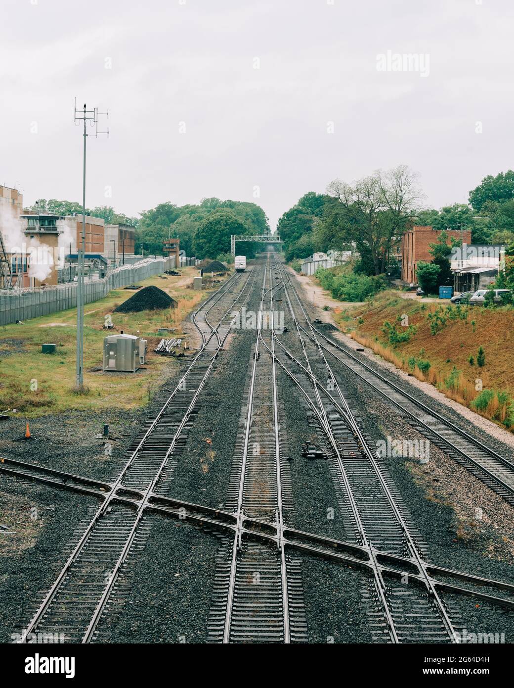 Train tracks with buildings and trees, Raleigh, North Carolina Stock