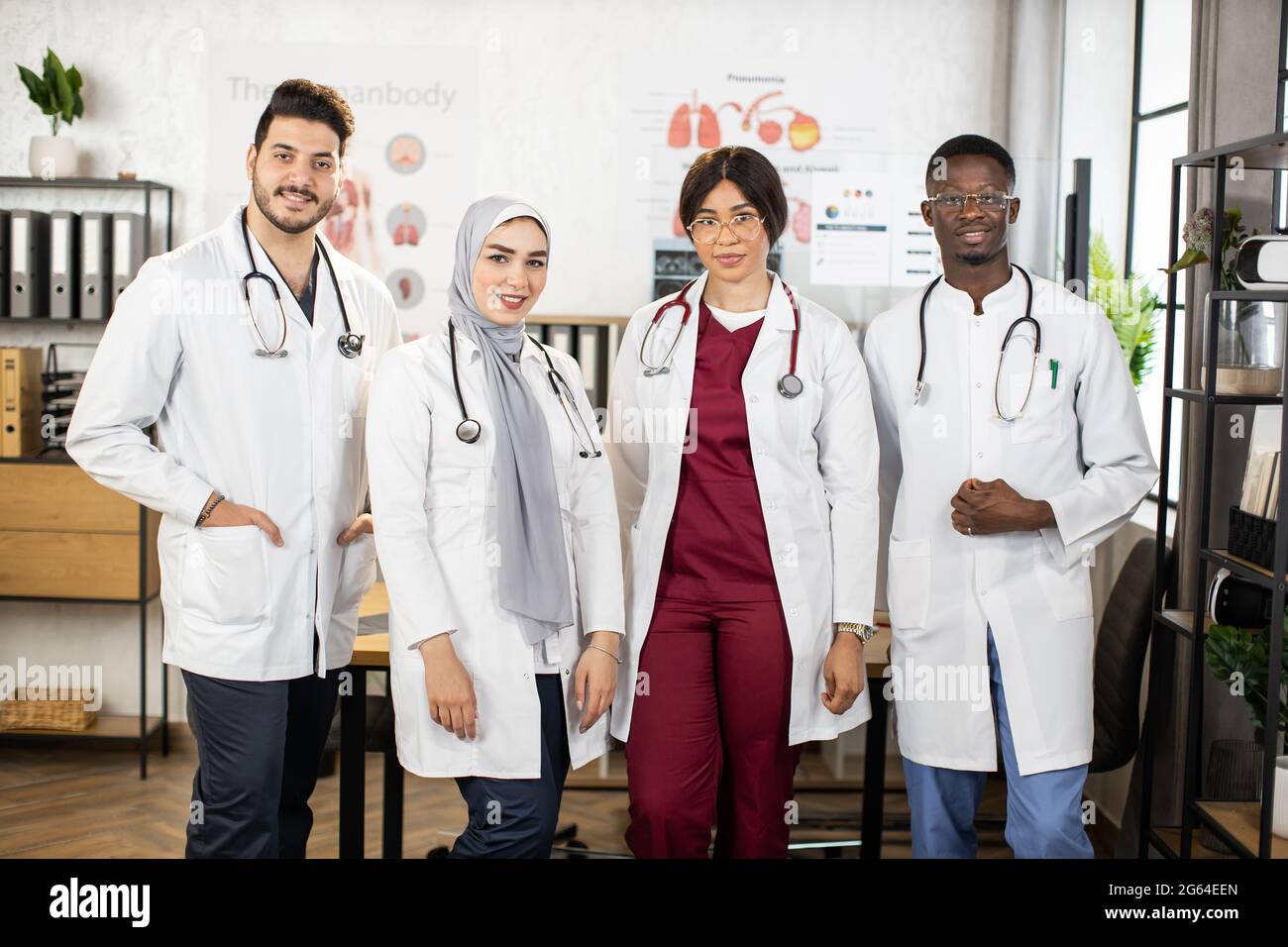 Portrait of four multicultural doctors wearing white lab coats and