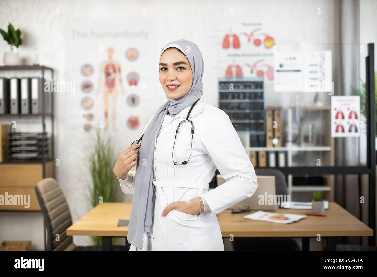 Muslim female doctor in hijab with stethoscope on neck posing at her