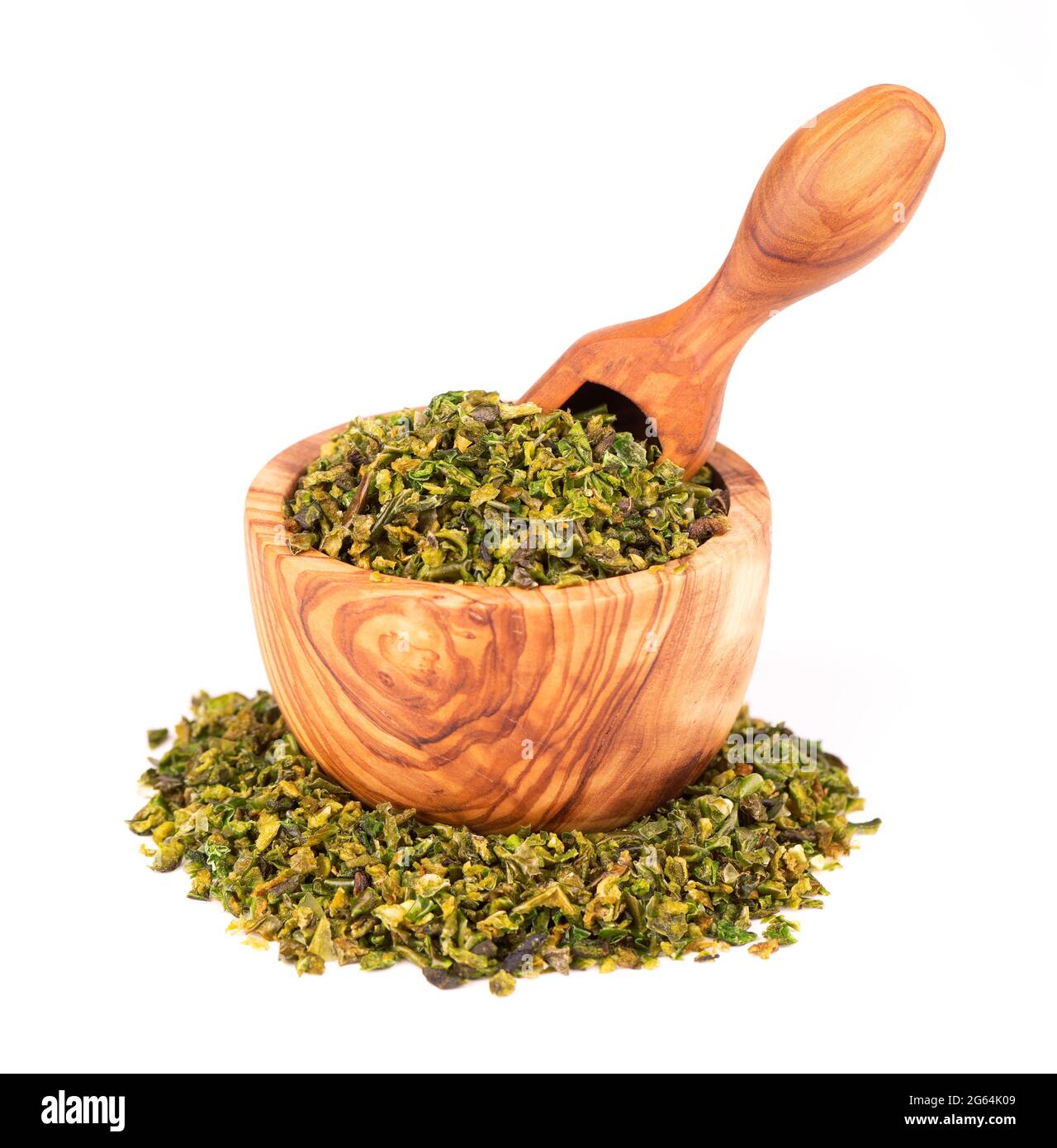 Dried green paprika flakes with seeds in olive bowl and scoop, isolated