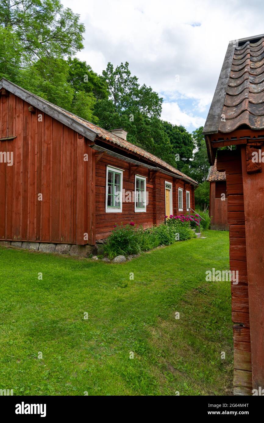 Gamla Uppsala, Sweden - 24 June, 2021: idyllic red cottages in the Swedish countryside with green meadows on a beautiful summer day Stock Photo